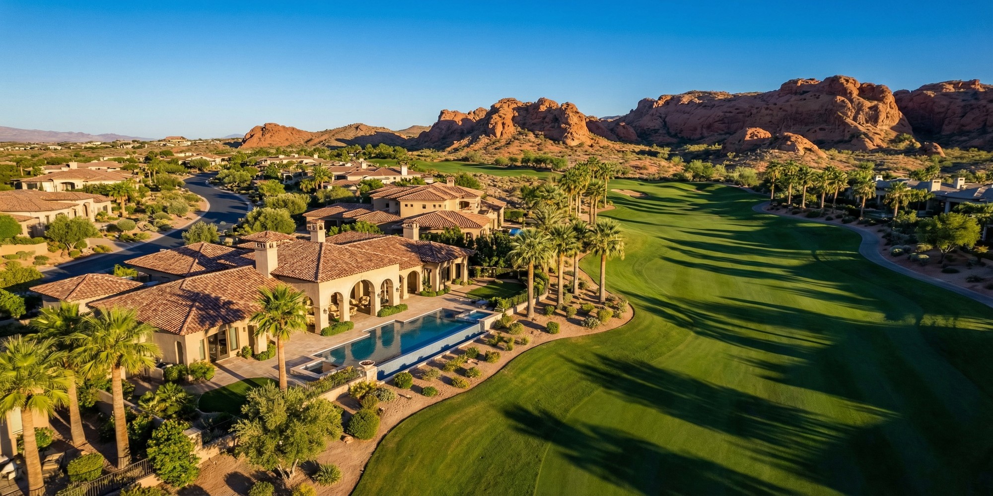Luxury guard-gated home backing TPC Summerlin fairway with Red Rock Canyon in the distance at golden hour